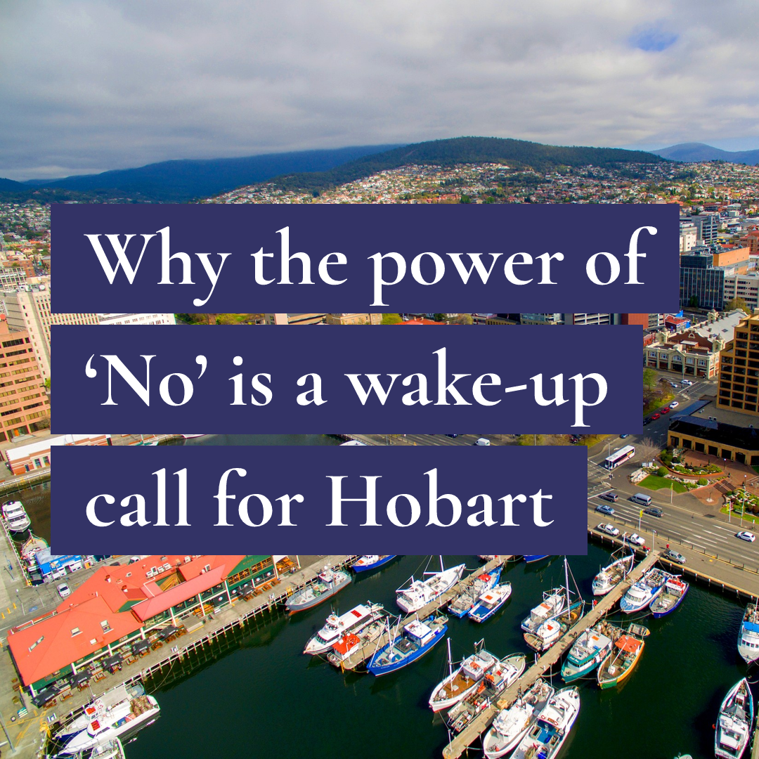 Aerial view of a harbour and city with text: Why the power of 'No' is a wake-up call for Hobart.
