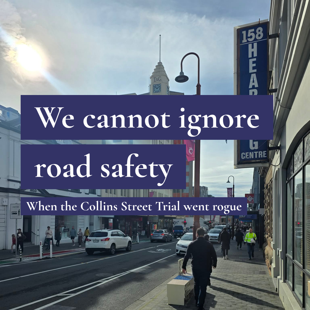 Pedestrians on a footpath and cars on a city street with text reading 'We cannot ignore road safety'.