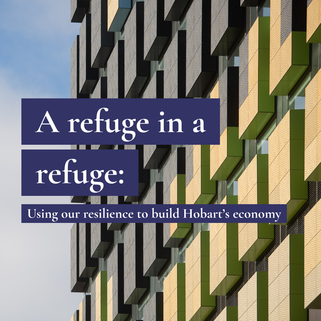 Modern building with green and yellow panels and text: A refuge in a refuge: Using our resilience to build Hobart's economy.